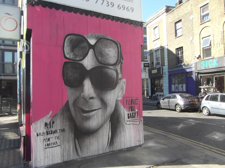 a mural of a man in sunglasses on the side of a building