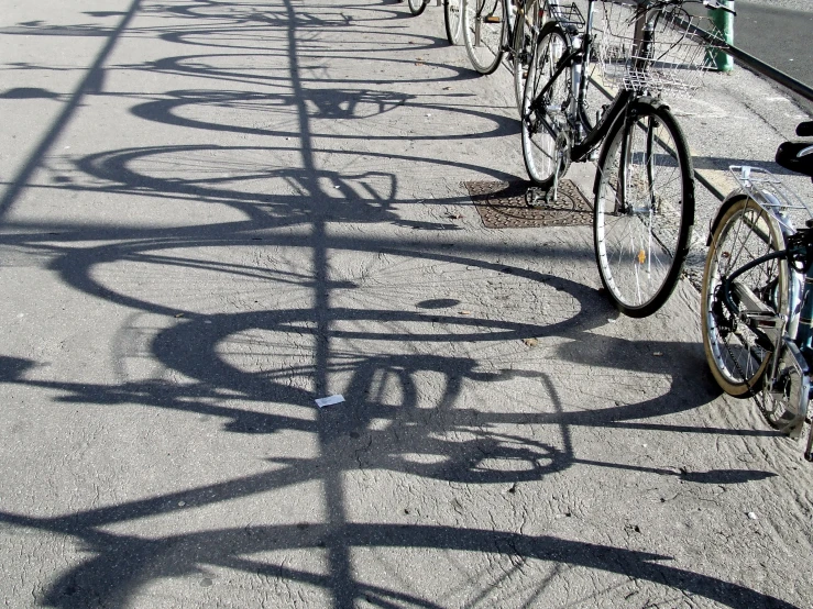 several bicycle's are lined up along the street