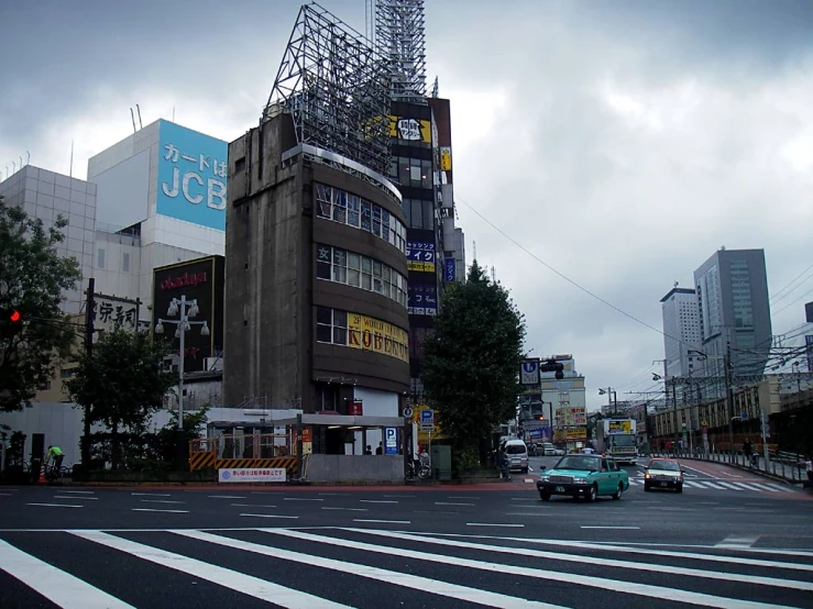 an intersection with cars and a building on the street