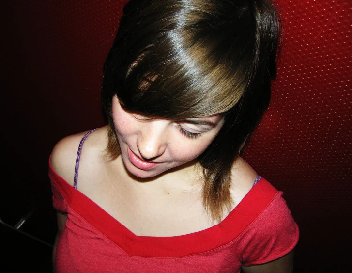 a young woman with a red shirt and a smile