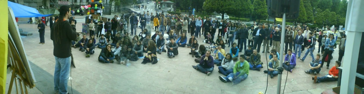 a crowd of people sitting around standing around some mirrors