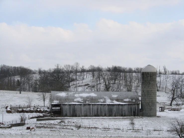 a snowy field with a large old building