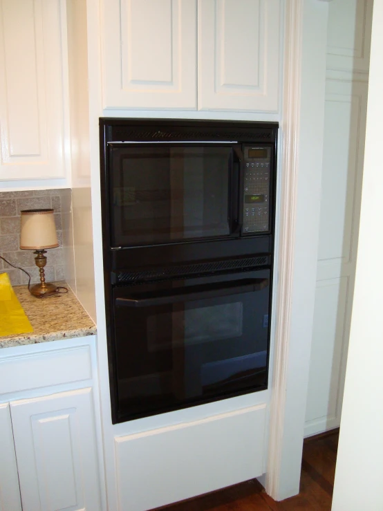 two microwave ovens mounted into the wall in the kitchen