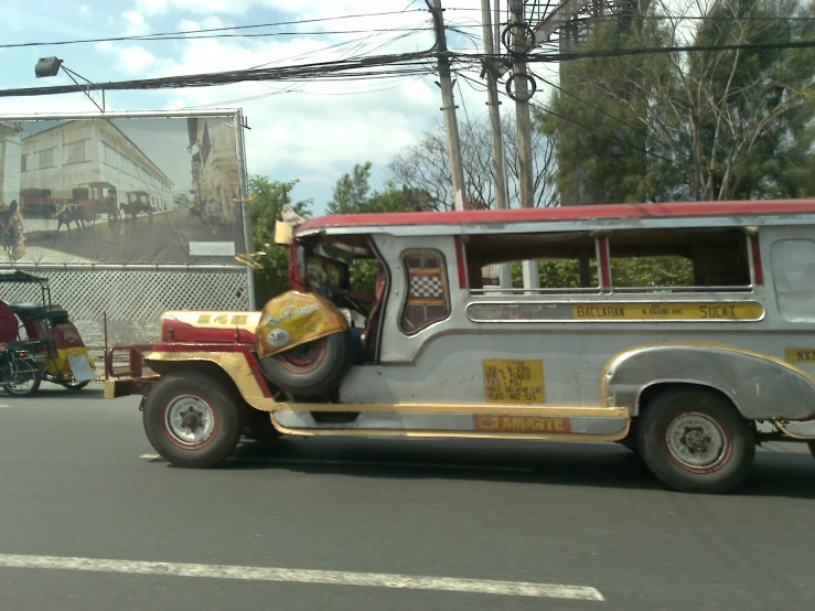 a yellow and red bus parked next to a street