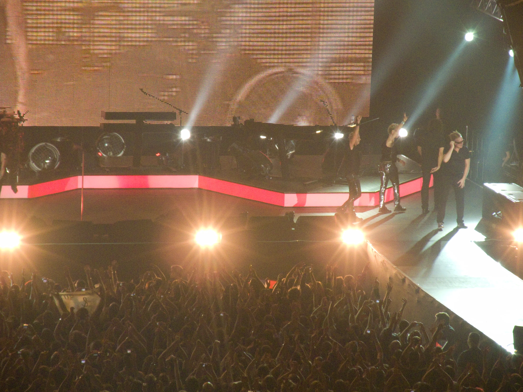 several people are standing on the stage to perform