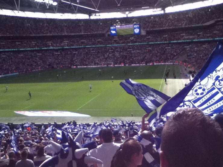 a stadium filled with fans holding up flags