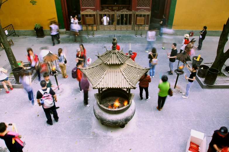 a bunch of people are gathered around a fire pit