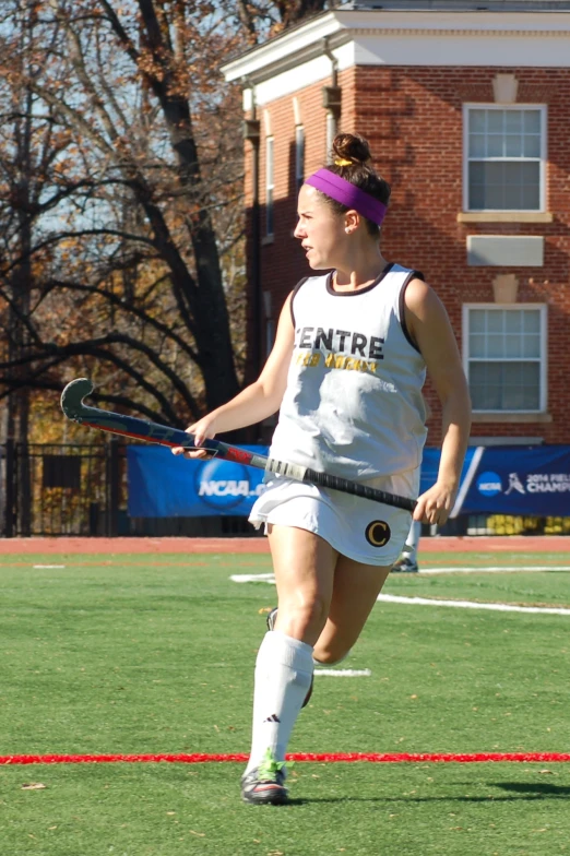 a person on a field with a lacrosse racket