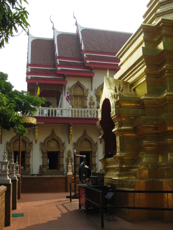 an ornate building with several golden columns and sculptures