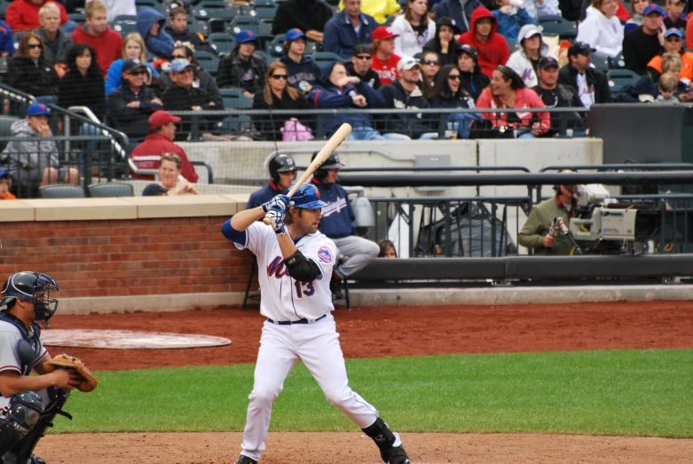 a baseball player holding a bat in front of fans