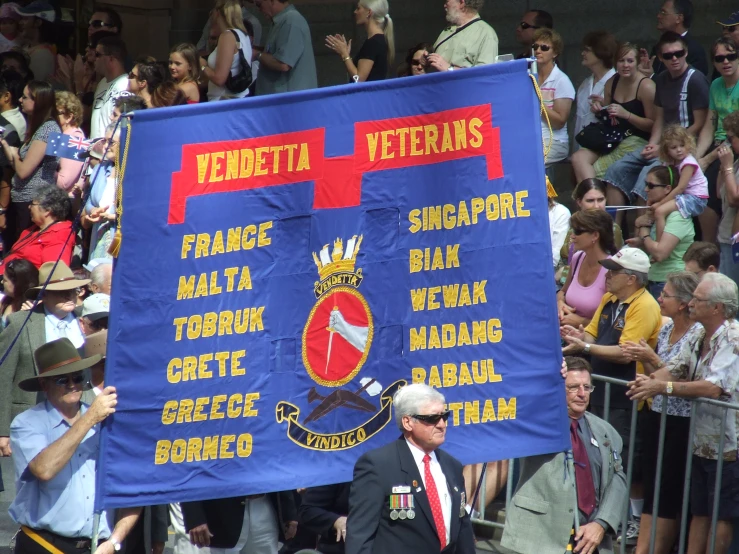 a man holding a banner is walking down the street