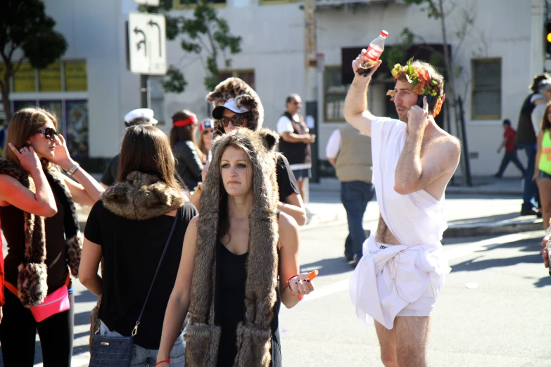 man in furry costumes with people walking down the street