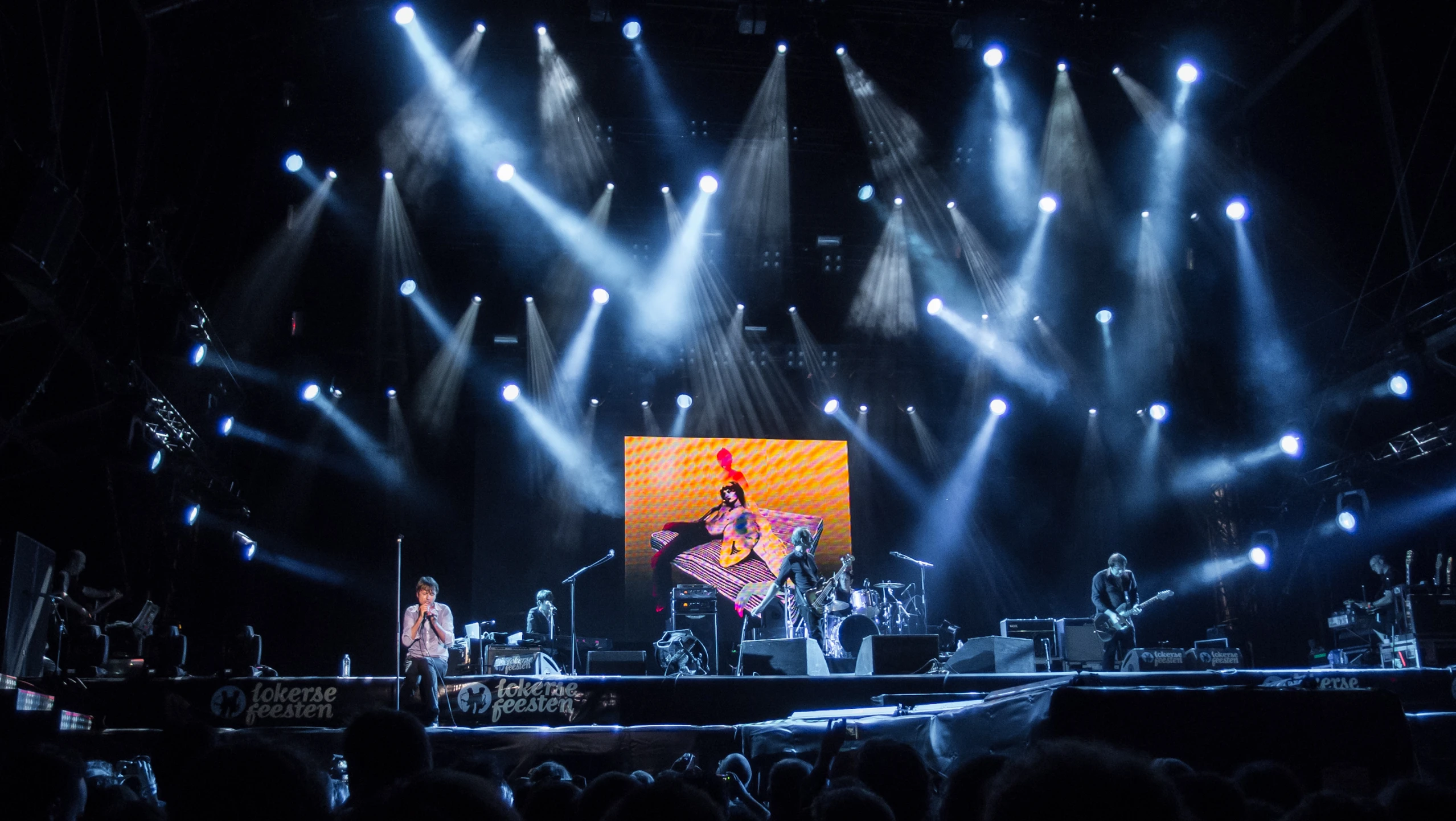 people watching and recording on stage with their instruments