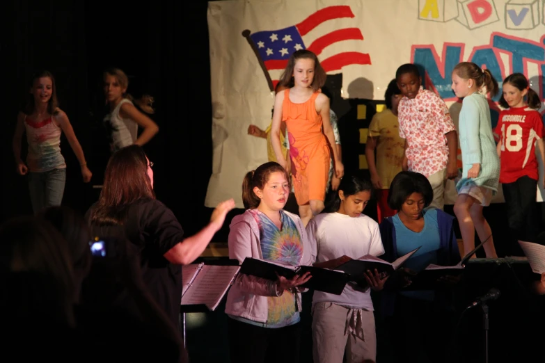 children in an assembly holding their instruments