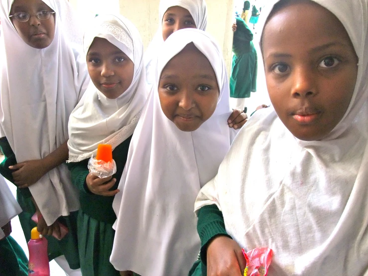 a group of children are posing for a picture