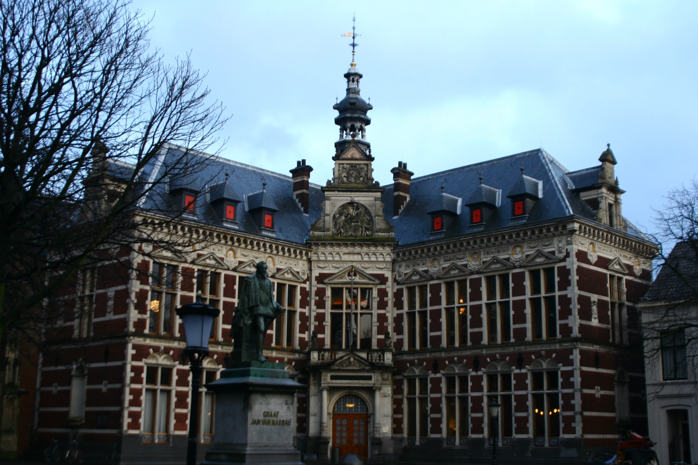 an ornate building has red and white shutters