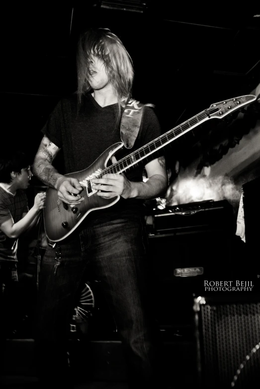 black and white image of guitarist playing an electric guitar