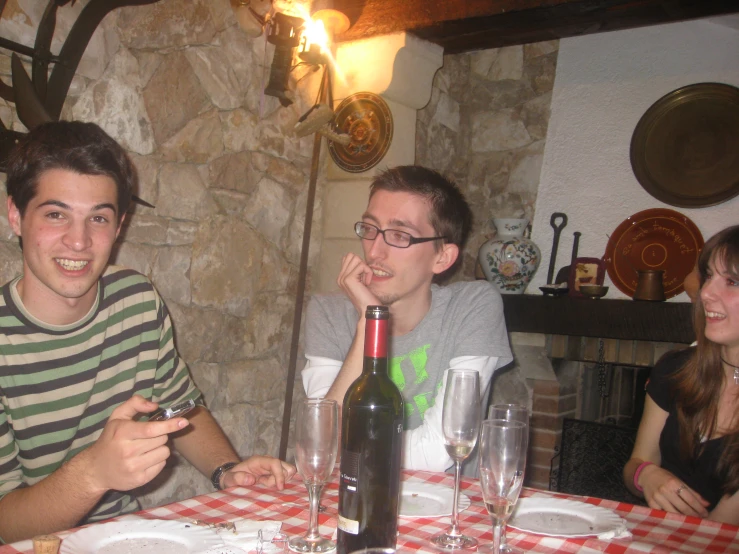 two boys sit next to one another at a table