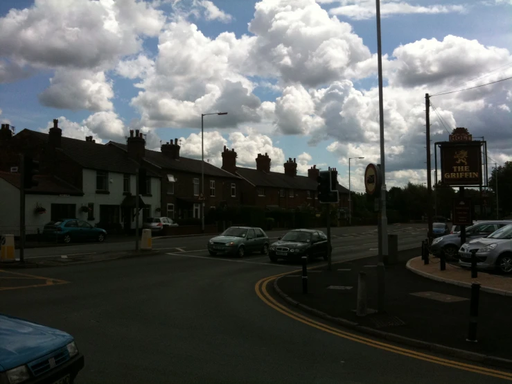 a parking lot in a residential area with parked cars