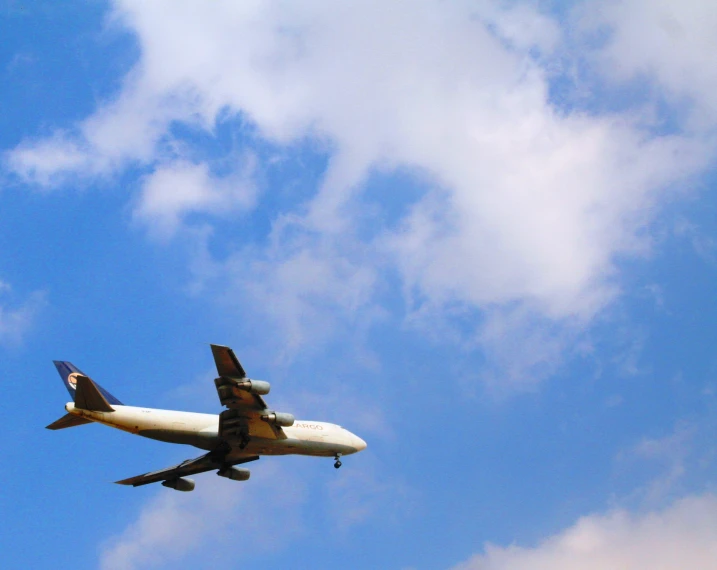 airplane flying up in the sky with a blue and white color