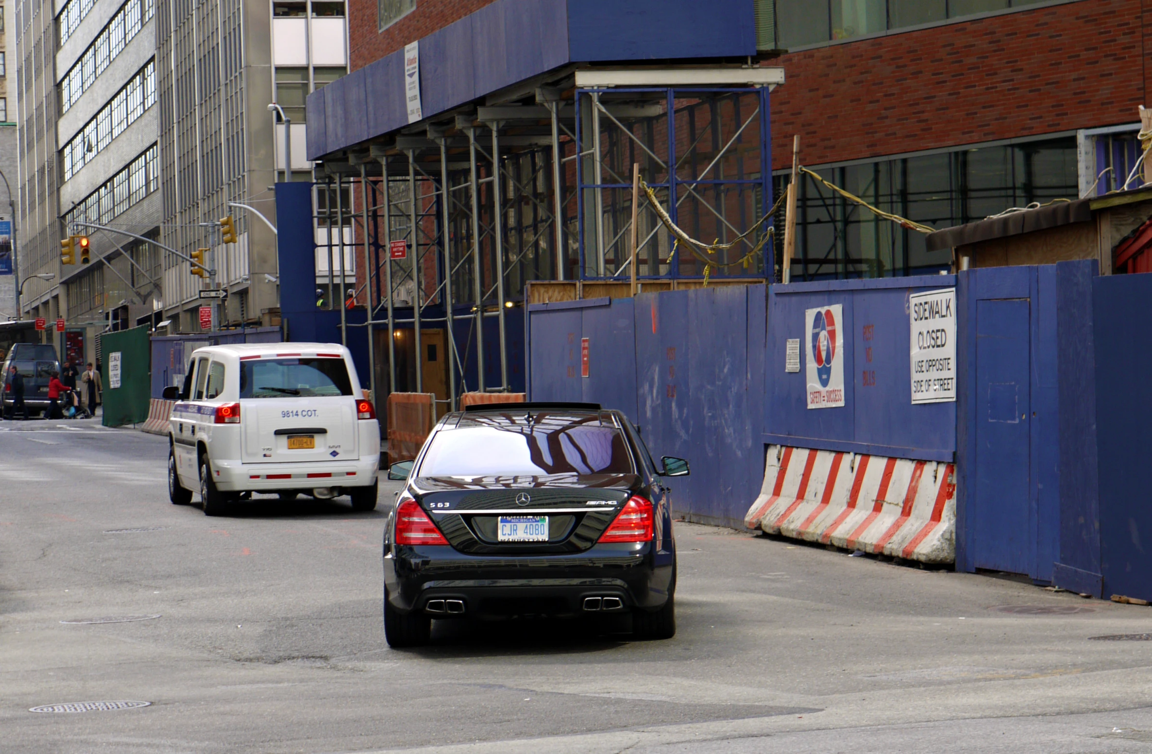 a black and silver car parked on a city street