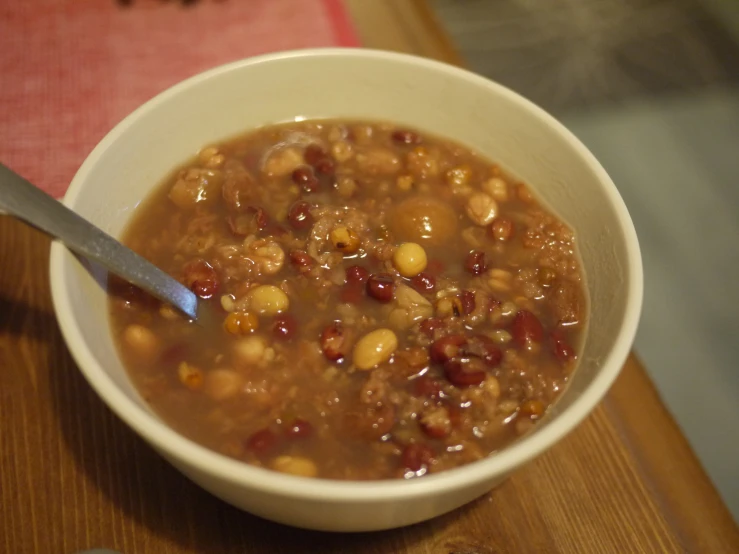 a bowl of beans and corn soup on a table