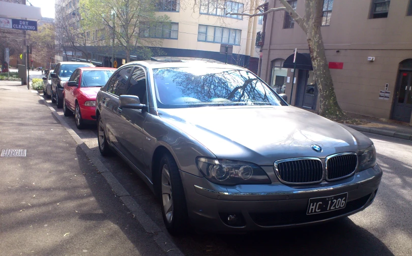 two cars parked on a curb next to each other