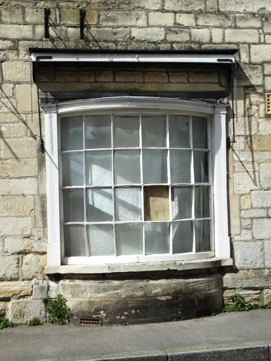 the broken window has been boarded off on a building