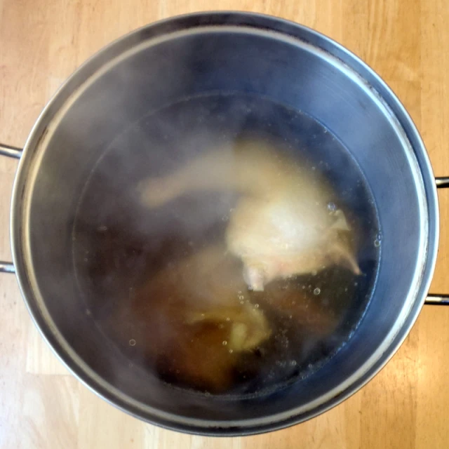 boiling in a pot on a wooden table