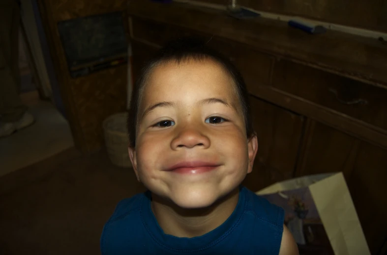 an image of a smiling boy with his eyes closed
