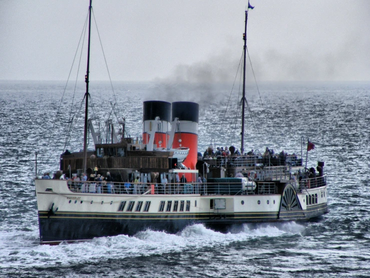 a tug boat with a lot of people on board