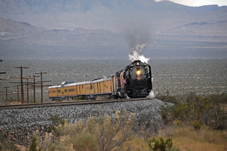 an electric train travels through the desert