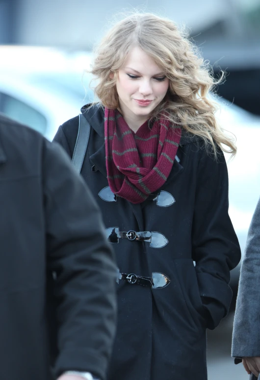 a woman wearing a red scarf is walking