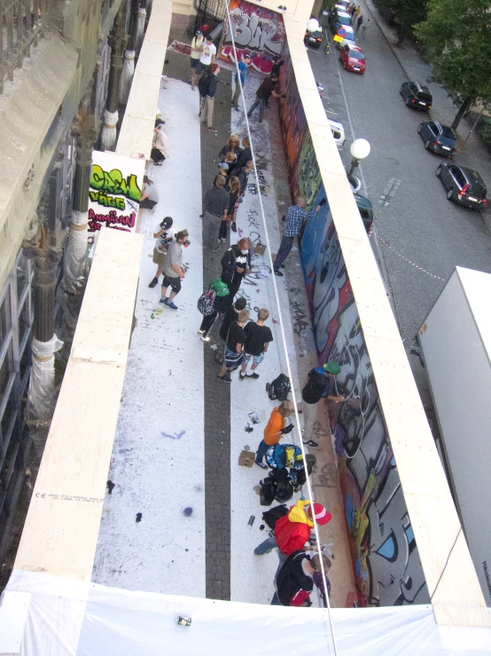 a group of people in the street next to cars