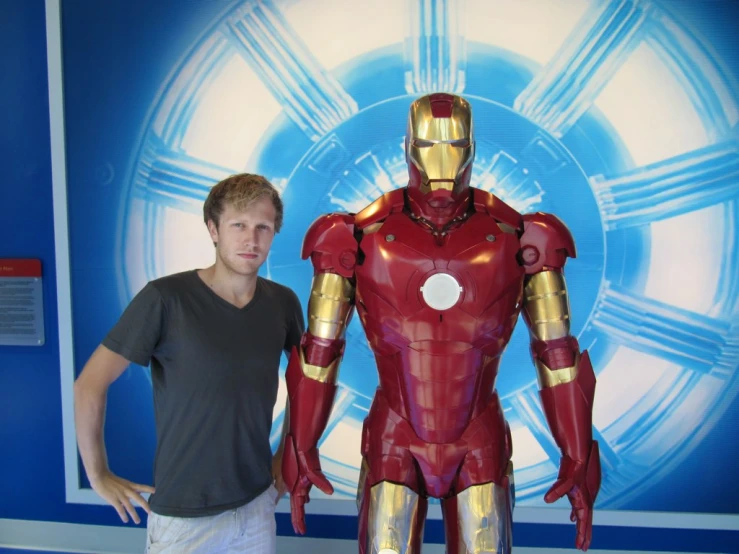 a man posing with a  ironman action figure