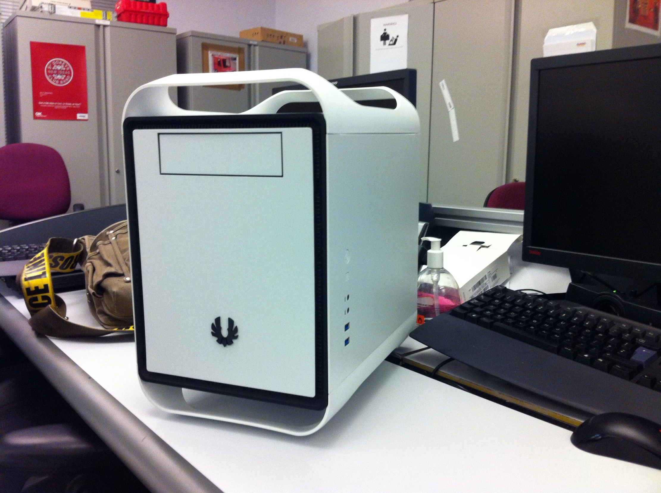 an empty white case on a table with a computer