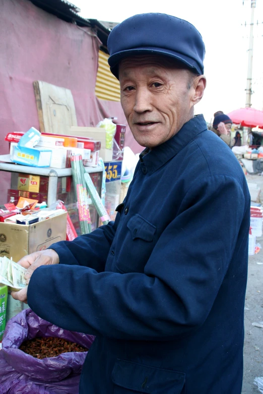 an older man holding soing in his hand in his hand