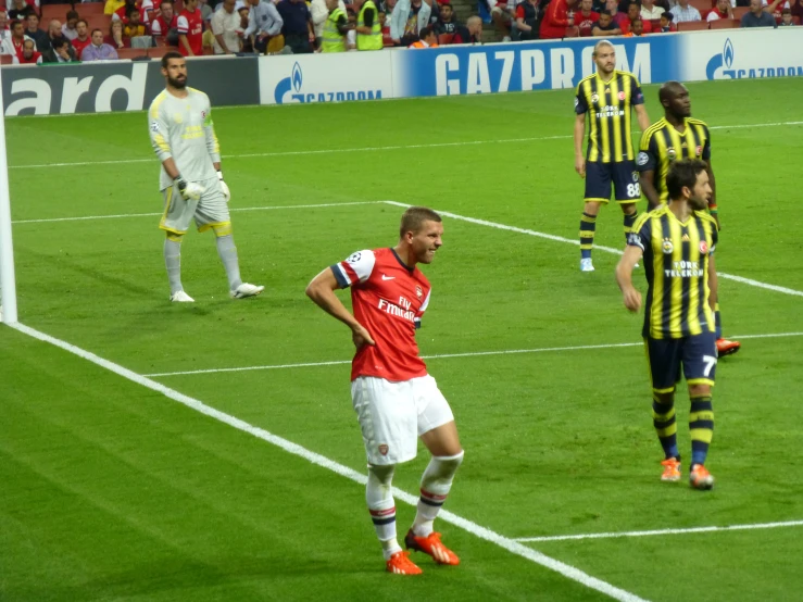 a group of players playing soccer on a field