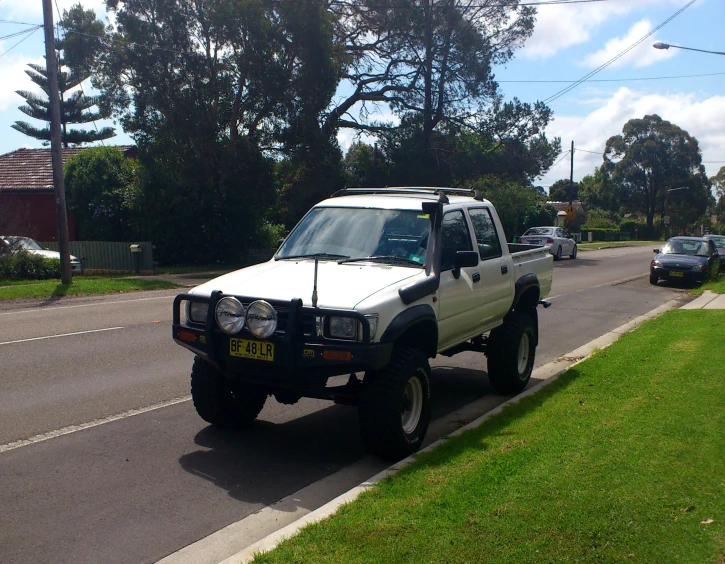 a suv is parked on the side of the street