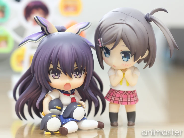 anime doll posed next to a chibi figure