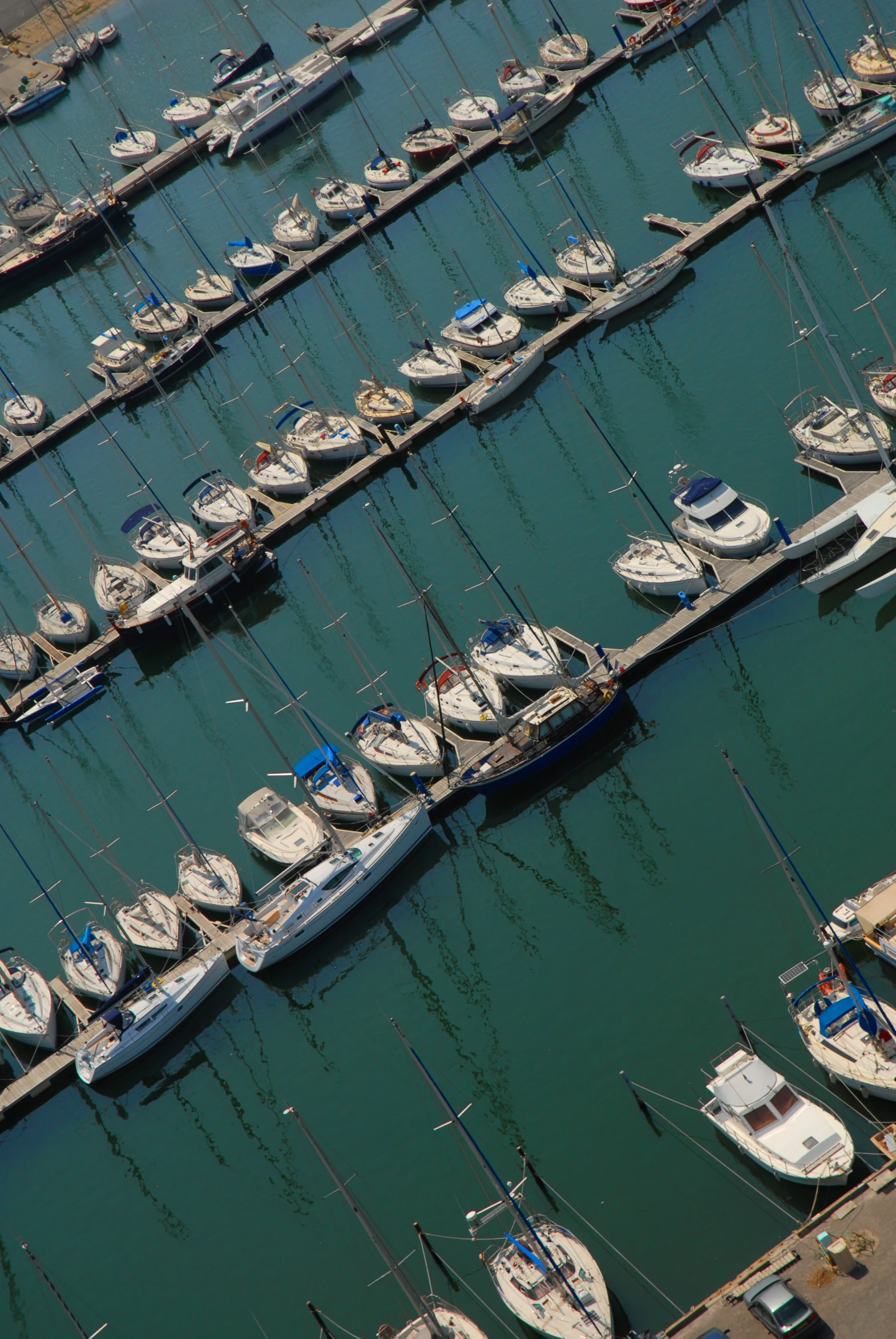 lots of boats are in the water at a marina