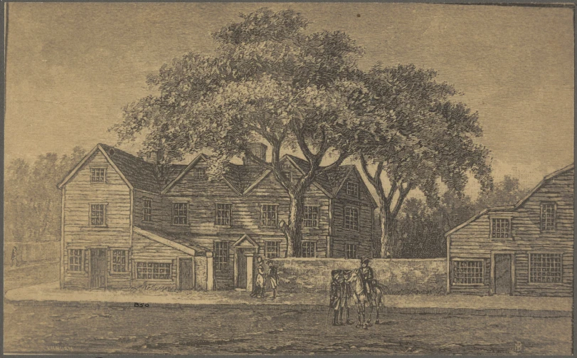 a couple of men standing next to each other in front of an old house