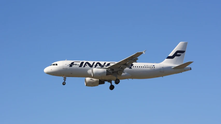 a large passenger jet flying through a clear blue sky