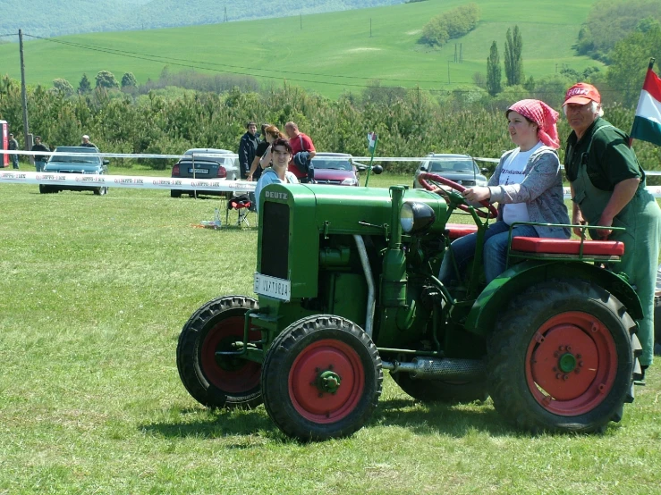 two women on tractors at an agricultural show