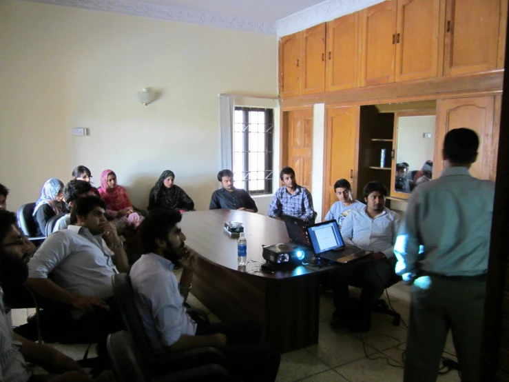 a group of people sitting around a table