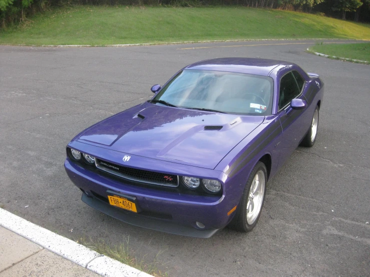 the violet car is parked in the lot