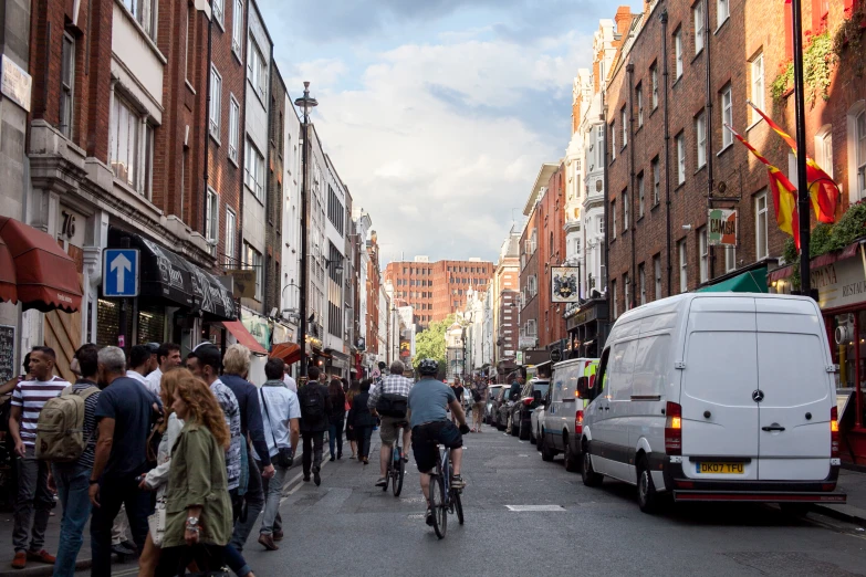 people riding bikes on a city street