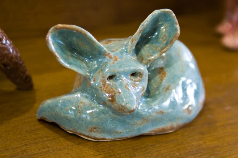 a small ceramic animal shaped like a rabbit