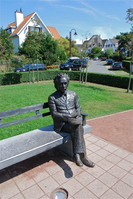 a metal statue sitting on top of a cement bench