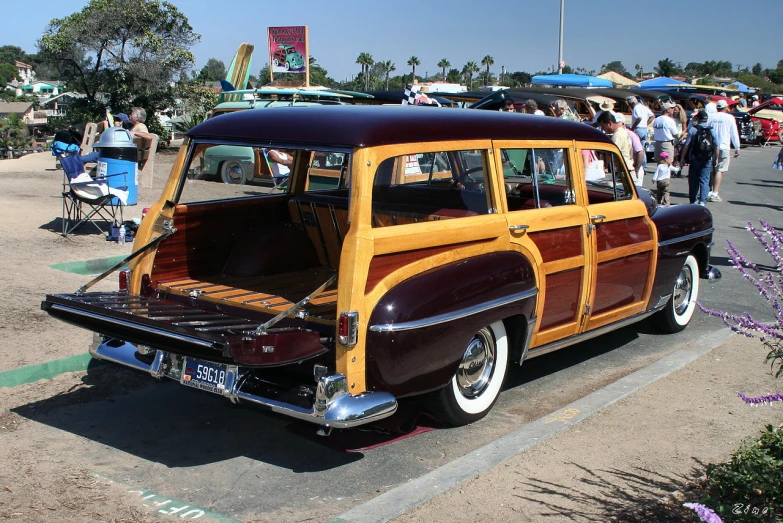 an old style brown station wagon with a wooden trunk